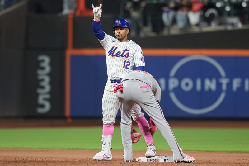 May 12, 2024; New York City, New York, USA; New York Mets shortstop Francisco Lindor (12) reacts after a double during the sixth inning as Atlanta Braves shortstop Orlando Arcia (11) tags at Citi Field. Mandatory Credit: Vincent Carchietta-USA TODAY Sports