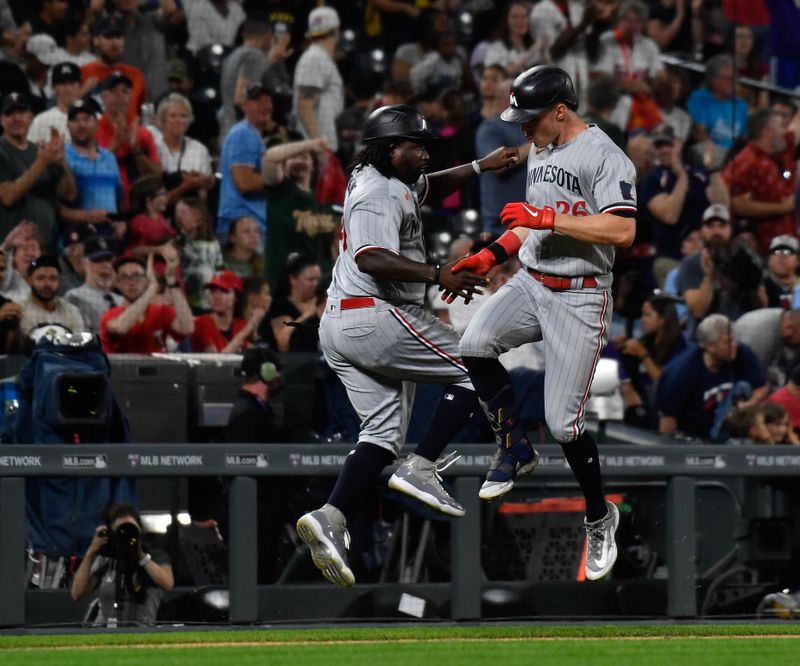 Sep 30, 2023; Denver, Colorado, USA; Minnesota Twins right fielder Max Kepler (26) celebrates his three run home run with Minnesota Twins third base coach/outfield coach Tommy Watkins (40) in the sixth inning against the Colorado Rockies at Coors Field. Mandatory Credit: John Leyba-USA TODAY Sports