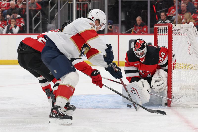 Oct 16, 2025; Newark, New Jersey, USA; New Jersey Devils goaltender Jake Allen (34) makes a save against the Florida Panthers during the third period at Prudential Center. Mandatory Credit: Ed Mulholland-Imagn Images