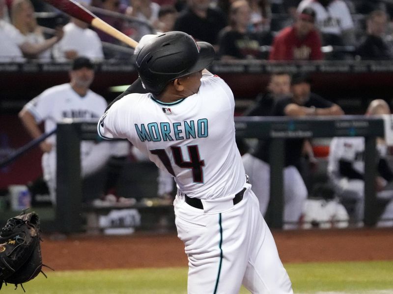 Apr 25, 2023; Phoenix, Arizona, USA; Arizona Diamondbacks catcher Gabriel Moreno (14) hits a single against the Kansas City Royals during the seventh inning at Chase Field. Mandatory Credit: Joe Camporeale-USA TODAY Sports