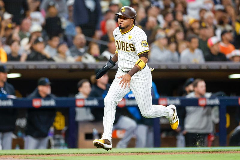 May 28, 2024; San Diego, California, USA; San Diego Padres first baseman Luis Arraez (4) scores on an RBI single by San Diego Padres left fielder Jurickson Profar (10) in the fifth inning against the Miami Marlins at Petco Park. Mandatory Credit: David Frerker-USA TODAY Sports