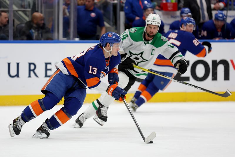 Jan 21, 2024; Elmont, New York, USA; New York Islanders center Mathew Barzal (13) skates with the puck against Dallas Stars left wing Jamie Benn (14) during the third period at UBS Arena. Mandatory Credit: Brad Penner-USA TODAY Sports