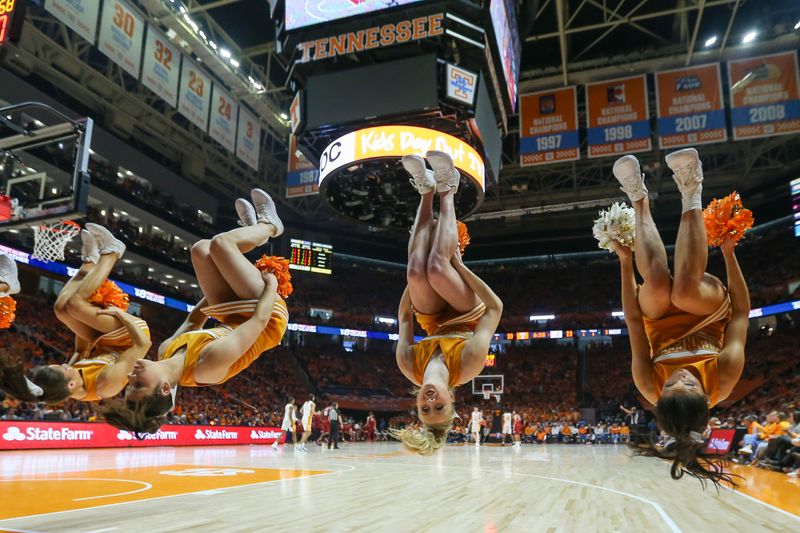 Jan 20, 2024; Knoxville, Tennessee, USA; The Tennessee Volunteers cheerleaders perform a backflip after a free throw against the Alabama Crimson Tide during the first half at Thompson-Boling Arena at Food City Center. Mandatory Credit: Randy Sartin-USA TODAY Sports