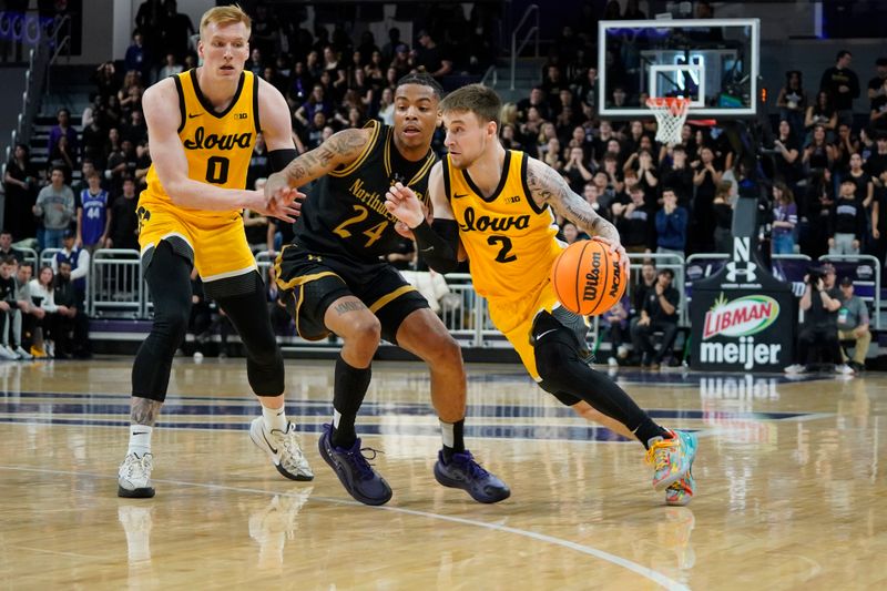 Feb 28, 2025; Evanston, Illinois, USA; Northwestern Wildcats guard K.J. Windham (24) defends Iowa Hawkeyes guard Brock Harding (2) during the first half at Welsh-Ryan Arena. Mandatory Credit: David Banks-Imagn Images