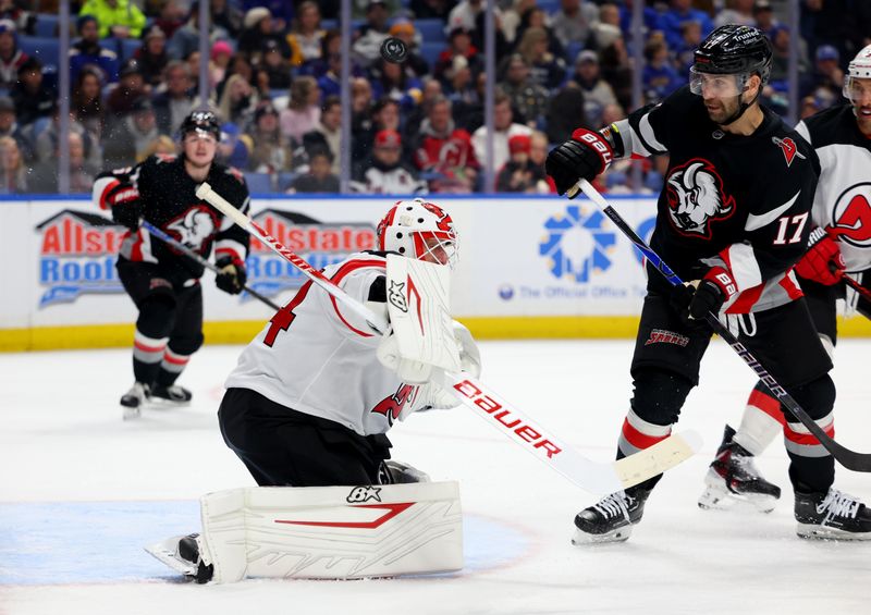 Nov 28, 2025; Buffalo, New York, USA;  Buffalo Sabres left wing Jason Zucker (17) watches as New Jersey Devils goaltender Jake Allen (34) makes a blocker save during the second period at KeyBank Center. Mandatory Credit: Timothy T. Ludwig-Imagn Images