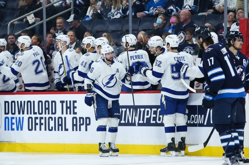 Jan 6, 2023; Winnipeg, Manitoba, CAN;  Tampa Bay Lightning forward Nikita Kucherov (86) is congratulated by his team mates on his goal against the Winnipeg Jets during the second period at Canada Life Centre. Mandatory Credit: Terrence Lee-USA TODAY Sports