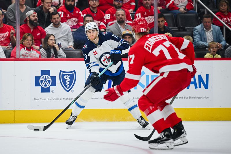 Oct 30, 2024; Detroit, Michigan, USA; Winnipeg Jets center Gabriel Vilardi (13) makes an assist to left wing Kyle Connor (not pictured) as Detroit Red Wings defenseman Simon Edvinsson (77) defends during the first period at Little Caesars Arena. Mandatory Credit: Tim Fuller-Imagn Images