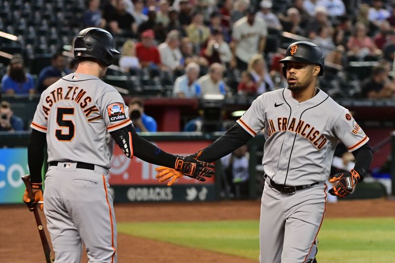 Sep 20, 2023; Phoenix, Arizona, USA;  San Francisco Giants first baseman LaMonte Wade Jr. (31) celebrates with center fielder Mike Yastrzemski (5) after hitting a solo home run in the first inning against the Arizona Diamondbacks at Chase Field. Mandatory Credit: Matt Kartozian-USA TODAY Sports