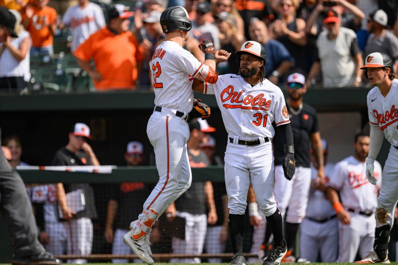 Aug 27, 2023; Baltimore, Maryland, USA; Baltimore Orioles first baseman Ryan O'Hearn (32) celebrates with center fielder Cedric Mullins (31) after hitting a two run home run during the eighth inning against the Colorado Rockies at Oriole Park at Camden Yards. Mandatory Credit: Reggie Hildred-USA TODAY Sports