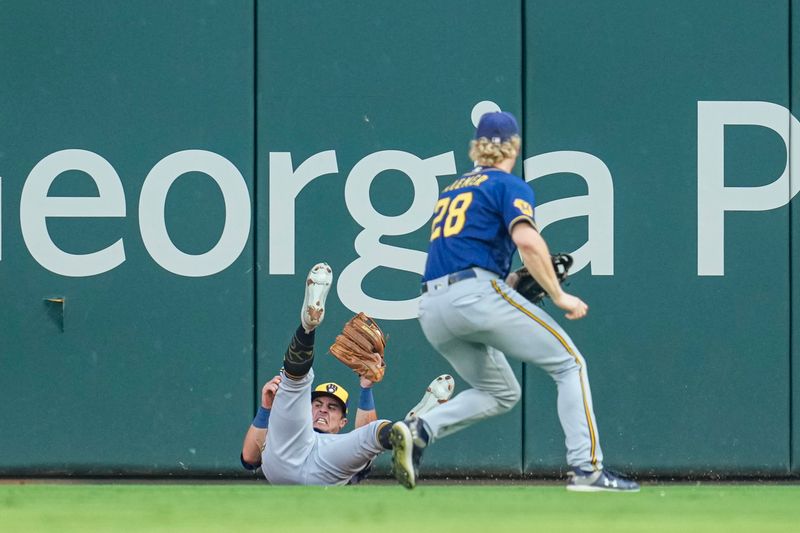 Jul 29, 2023; Cumberland, Georgia, USA; Milwaukee Brewers outfielder Sal Frelick (10) makes a sliding catch on a ball hit by Atlanta Braves catcher Travis d'Arnaud (16) (not shown) during the first inning at Truist Park. Mandatory Credit: Dale Zanine-USA TODAY Sports