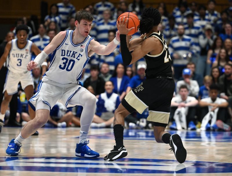 Feb 12, 2024; Durham, North Carolina, USA;  Wake Forest Deamon Deacons guard Hunter Sallis (23) is pressured by Duke Blue Devils center Kyle Filipowski (30) during the second half at Cameron Indoor Stadium. The Blue Devils won 77-69. Mandatory Credit: Rob Kinnan-USA TODAY Sports