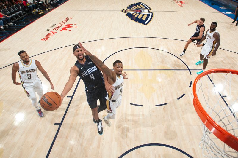 NEW ORLEANS, LA - OCTOBER 7: Jalen Suggs #4 of the Orlando Magic drives to the basket during the game against the New Orleans Pelicans on October 7, 2024 at the Smoothie King Center in New Orleans, Louisiana. NOTE TO USER: User expressly acknowledges and agrees that, by downloading and or using this Photograph, user is consenting to the terms and conditions of the Getty Images License Agreement. Mandatory Copyright Notice: Copyright 2024 NBAE (Photo by Layne Murdoch Jr./NBAE via Getty Images)