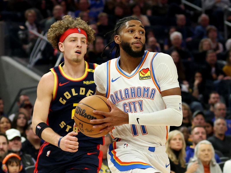 SAN FRANCISCO, CALIFORNIA - NOVEMBER 27: Isaiah Joe #11 of the Oklahoma City Thunder drives to the basket against Brandin Podziemski #2 of the Golden State Warriors during the first half at Chase Center on November 27, 2024 in San Francisco, California. NOTE TO USER: User expressly acknowledges and agrees that, by downloading and or using this photograph, User is consenting to the terms and conditions of the Getty Images License Agreement (Photo by Ezra Shaw/Getty Images)