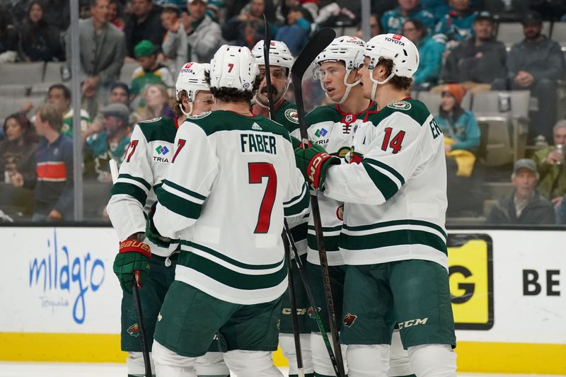 Apr 13, 2024; San Jose, California, USA; Minnesota Wild defenseman Brock Faber (7) and Minnesota Wild center Joel Eriksson Ek (14) celebrate after Minnesota Wild left wing Matt Boldy (12) scores a goal during the first period at SAP Center at San Jose. Mandatory Credit: David Gonzales-USA TODAY Sports