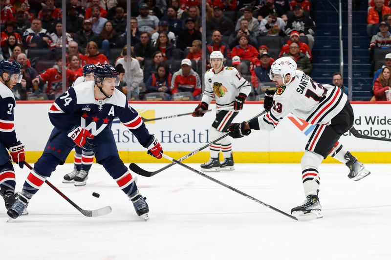 Mar 9, 2024; Washington, District of Columbia, USA; Chicago Blackhawks left wing Zach Sanford (13) shoots the puck as Washington Capitals defenseman John Carlson (74) defends in the second period at Capital One Arena. Mandatory Credit: Geoff Burke-USA TODAY Sports