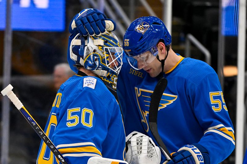 Jan 20, 2024; St. Louis, Missouri, USA;  St. Louis Blues goaltender Jordan Binnington (50) and defenseman Colton Parayko (55) celebrate after the Blues defeated the Washington Capitals at Enterprise Center. Mandatory Credit: Jeff Curry-USA TODAY Sports