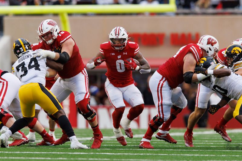 Oct 14, 2023; Madison, Wisconsin, USA;  Wisconsin Badgers running back Braelon Allen (0) rushes with the football during the third quarter against the Iowa Hawkeyes at Camp Randall Stadium. Mandatory Credit: Jeff Hanisch-USA TODAY Sports