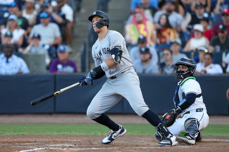 Apr 19, 2025; Tampa, Florida, USA; New York Yankees right fielder Aaron Judge (99) hits an rbi single against the Tampa Bay Rays in the ninth inning at George M. Steinbrenner Field. Mandatory Credit: Nathan Ray Seebeck-Imagn Images