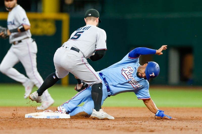 Aug 6, 2023; Arlington, Texas, USA; Texas Rangers second baseman Marcus Semien (2) steals second base as Miami Marlins shortstop Jon Berti (5) bobbles the throw during the third inning at Globe Life Field. Mandatory Credit: Andrew Dieb-USA TODAY Sports