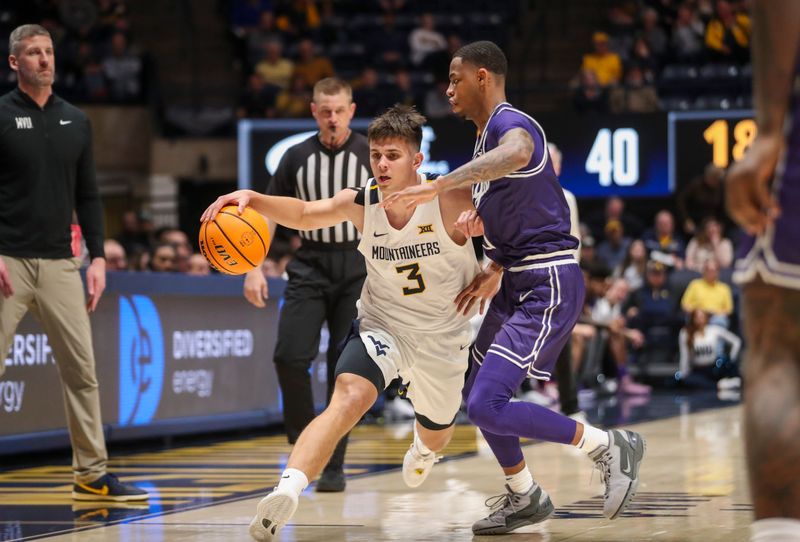 Mar 6, 2024; Morgantown, West Virginia, USA; West Virginia Mountaineers guard Kerr Kriisa (3) dribbles against TCU Horned Frogs guard Avery Anderson III (3) during the second half at WVU Coliseum. Mandatory Credit: Ben Queen-USA TODAY Sports