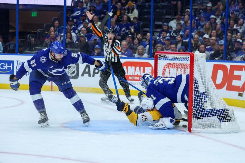Mar 29, 2026; Tampa, Florida, USA;  Nashville Predators right wing Joakim Kemell (25) crashes into Tampa Bay Lightning goaltender Jonas Johansson (31) scoring a goal in the second period at Benchmark International Arena. Mandatory Credit: Nathan Ray Seebeck-Imagn Images