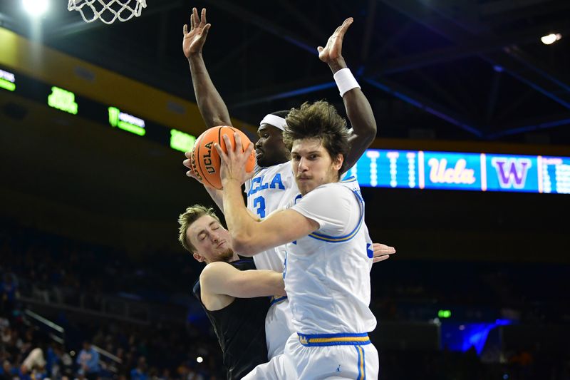 January 14, 2024; Los Angeles, California, USA; UCLA Bruins forward Berke Buyuktuncel (9) gets the rebound as forward Adem Bona (3) provides coverage against Washington Huskies guard Paul Mulcahy (9) during the first half at Pauley Pavilion. Mandatory Credit: Gary A. Vasquez-USA TODAY Sports