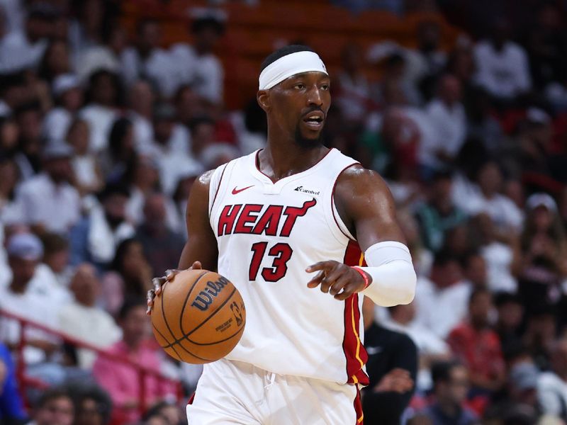 MIAMI, FLORIDA - APRIL 27: Bam Adebayo #13 of the Miami Heat dribbles the ball against the Boston Celtics during the third quarter in game three of the Eastern Conference First Round Playoffs at Kaseya Center on April 27, 2024 in Miami, Florida.  NOTE TO USER: User expressly acknowledges and agrees that, by downloading and or using this photograph, User is consenting to the terms and conditions of the Getty Images License Agreement. (Photo by Megan Briggs/Getty Images)