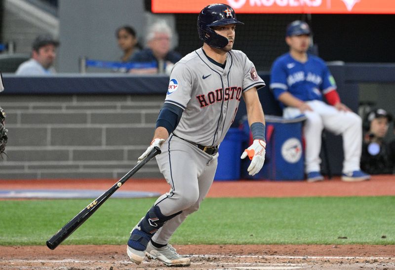 Jul 2, 2024; Toronto, Ontario, CAN;  Houston Astros catcher Cesar Salazar (18) hits an RBI single against the Toronto Blue Jays in the fifth inning at Rogers Centre. Mandatory Credit: Dan Hamilton-USA TODAY Sports