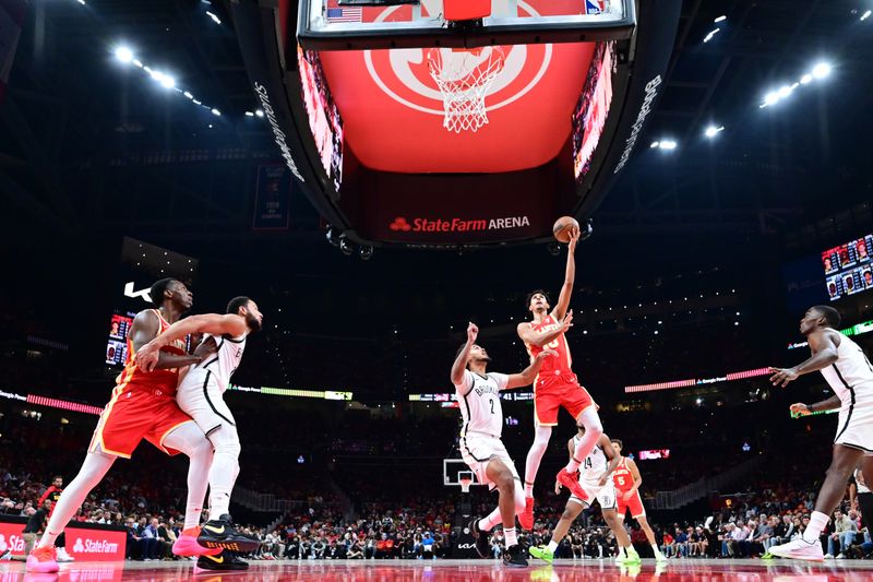 ATLANTA, GA - OCTOBER 23: Zaccharie Risacher #10 of the Atlanta Hawks shoots the ball during the game against the Brooklyn Nets on October 23, 2024 at State Farm Arena in Atlanta, Georgia.  NOTE TO USER: User expressly acknowledges and agrees that, by downloading and/or using this Photograph, user is consenting to the terms and conditions of the Getty Images License Agreement. Mandatory Copyright Notice: Copyright 2024 NBAE (Photo by Adam Hagy/NBAE via Getty Images)