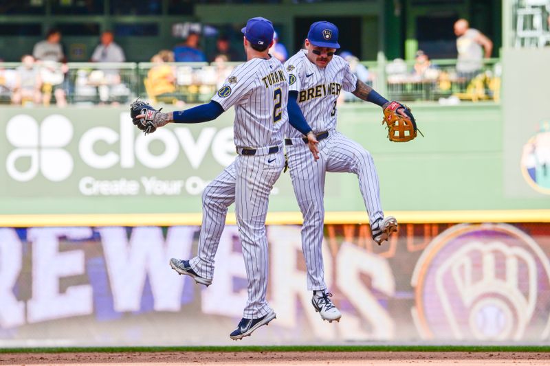 Jun 28, 2025; Milwaukee, Wisconsin, USA;  Milwaukee Brewers second baseman Brice Turang (2) and shortstop Joey Ortiz (3) celebrates after beating the Colorado Rockies at American Family Field. Mandatory Credit: Benny Sieu-Imagn Images