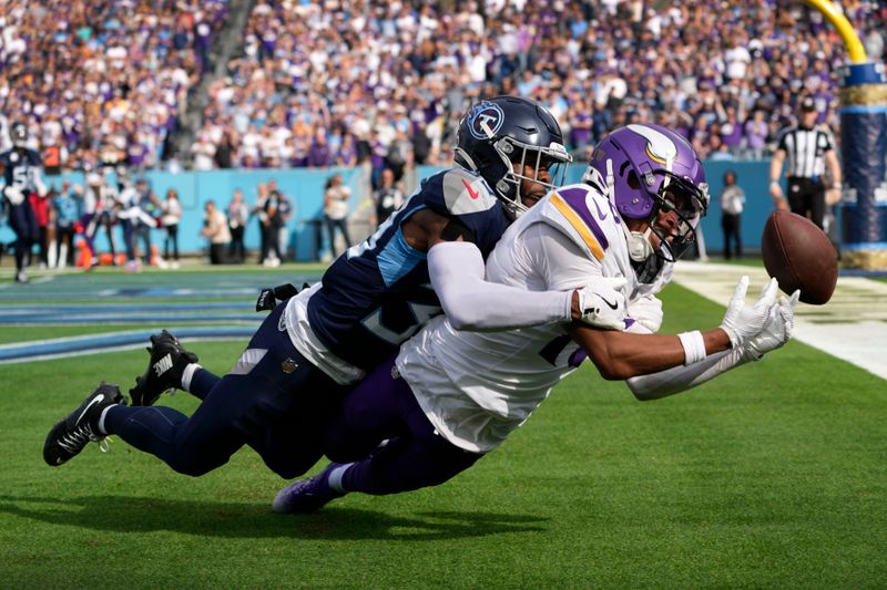 Tennessee Titans cornerback Darrell Baker Jr., left, breaks up a pass intended for Minnesota Vikings wide receiver Justin Jefferson (18) during the first half of an NFL football game, Sunday, Nov. 17, 2024, in Nashville, Tenn. (AP Photo/George Walker IV)