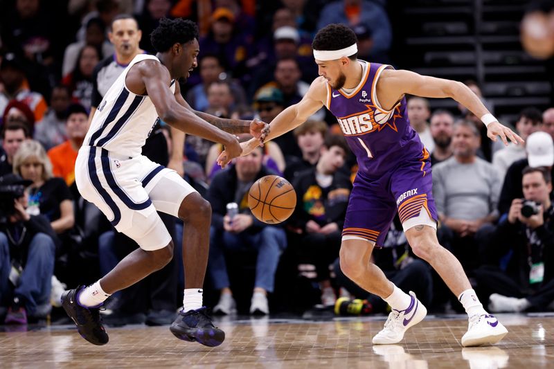 PHOENIX, ARIZONA - JANUARY 07: Vince Williams Jr. #5 of the Memphis Grizzlies and Devin Booker #1 of the Phoenix Suns battle for control of a loose ball during the first half at Footprint Center on January 07, 2024 in Phoenix, Arizona. NOTE TO USER: User expressly acknowledges and agrees that, by downloading and or using this photograph, User is consenting to the terms and conditions of the Getty Images License Agreement.  (Photo by Chris Coduto/Getty Images)