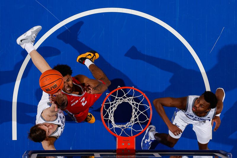 Feb 10, 2023; Colorado Springs, Colorado, USA; New Mexico Lobos guard Donovan Dent (2) takes a shot against Air Force Falcons guard Camden Vander Zwaag (30) and guard Ethan Taylor (5) in the first half at Clune Arena. Mandatory Credit: Isaiah J. Downing-USA TODAY Sports