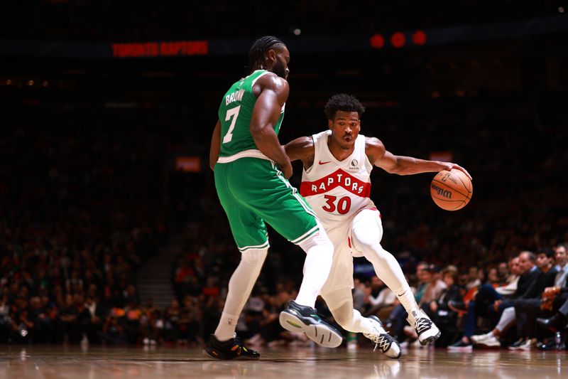 TORONTO, CANADA - OCTOBER 15: Ochai Agbaji #30 of the Toronto Raptors dribbles the ball during the game against the Boston Celtics on October 15, 2024 at the Scotiabank Arena in Toronto, Ontario, Canada.  NOTE TO USER: User expressly acknowledges and agrees that, by downloading and or using this Photograph, user is consenting to the terms and conditions of the Getty Images License Agreement.  Mandatory Copyright Notice: Copyright 2024 NBAE (Photo by Vaughn Ridley/NBAE via Getty Images)