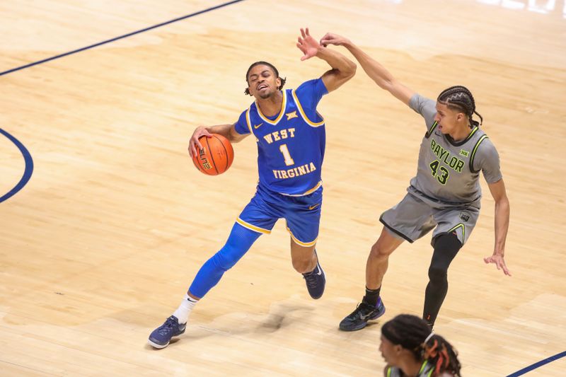 Jan 31, 2026; Morgantown, West Virginia, USA; West Virginia Mountaineers guard Jasper Floyd (1) dribbles against Baylor Bears guard Cameron Carr (43) during the second half at Hope Coliseum. Mandatory Credit: Ben Queen-Imagn Images