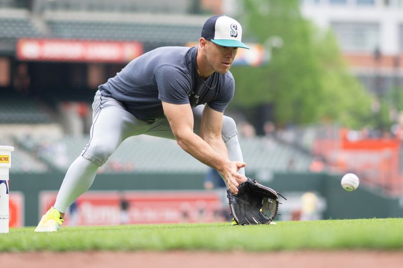 May 18, 2024; Baltimore, Maryland, USA; Seattle Mariners shortstop Dylan Moore (25) takes infield practice prior to the game against the Baltimore Orioles at Oriole Park at Camden Yards. Mandatory Credit: Gregory Fisher-USA TODAY Sports