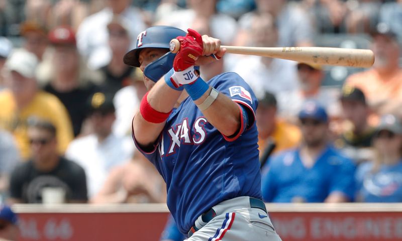 May 24, 2023; Pittsburgh, Pennsylvania, USA; Texas Rangers third baseman Josh Jung (6) hits an RBI double against the Pittsburgh Pirates during the first inning at PNC Park. Mandatory Credit: Charles LeClaire-USA TODAY Sports