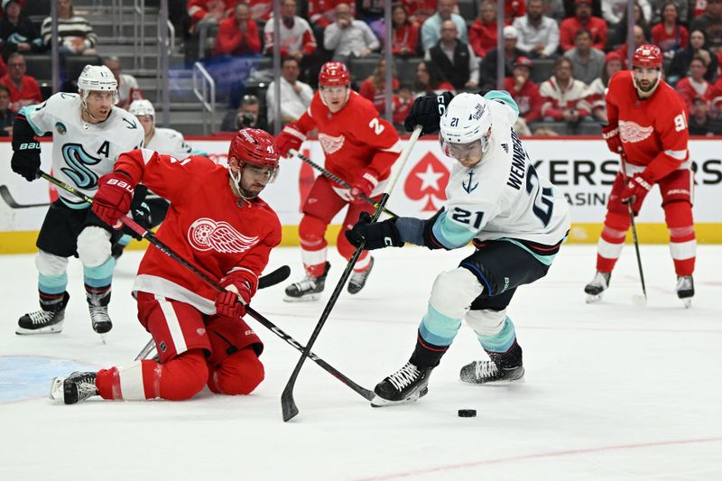 Oct 24, 2023; Detroit, Michigan, USA; Seattle Kraken center Alex Wennberg (21) tries to maneuver past Detroit Red Wings defenseman Shayne Gostisbehere (41) in the third period at Little Caesars Arena. Mandatory Credit: Lon Horwedel-USA TODAY Sports