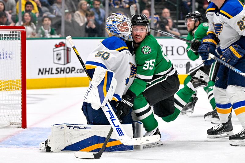 Dec 14, 2024; Dallas, Texas, USA; Dallas Stars center Matt Duchene (95) is checked into St. Louis Blues goaltender Jordan Binnington (50) by defenseman Ryan Suter (22) during the second period at American Airlines Center. Mandatory Credit: Jerome Miron-Imagn Images