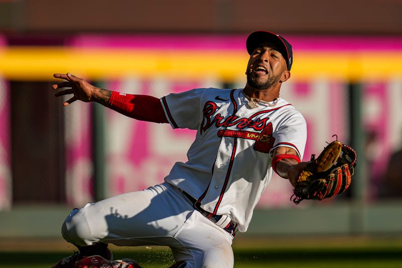 Oct 1, 2023; Cumberland, Georgia, USA; Atlanta Braves left fielder Eddie Rosario (8) makes a sliding catch on a ball hit by Washington Nationals shortstop CJ Abrams (5) (not shown) during the eighth inning at Truist Park. Mandatory Credit: Dale Zanine-USA TODAY Sports