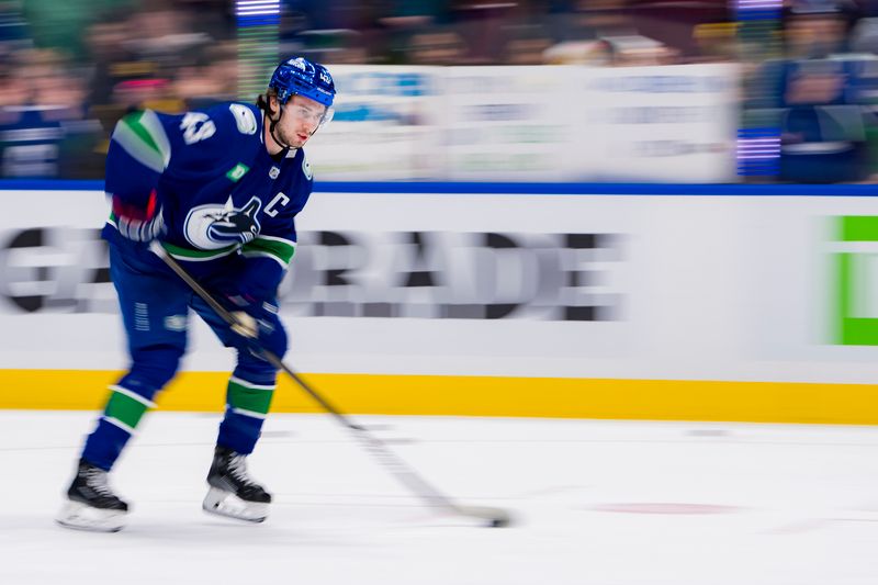 Jan 24, 2024; Vancouver, British Columbia, CAN; Vancouver Canucks defenseman Quinn Hughes (43) handles the puck during warm up prior to a game against the St. Louis Blues at Rogers Arena. Mandatory Credit: Bob Frid-USA TODAY Sports