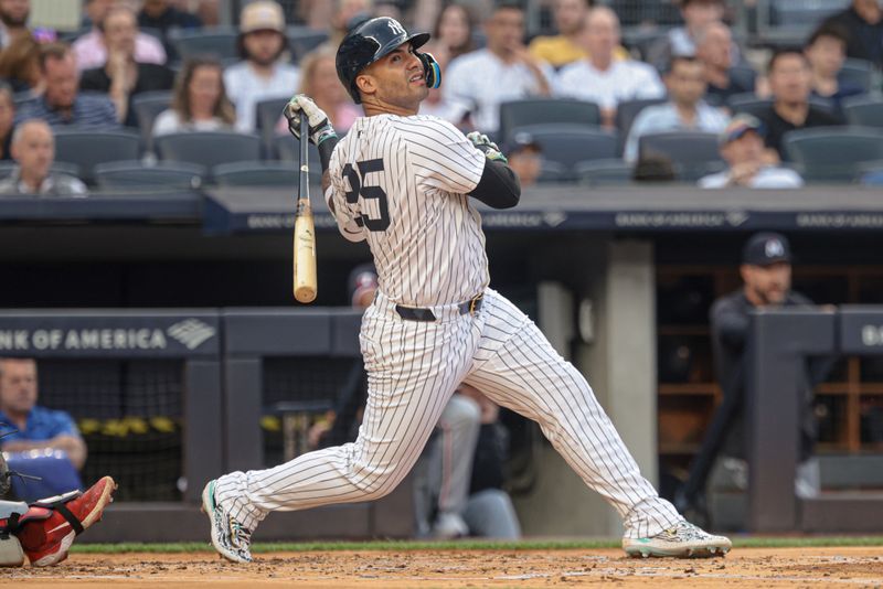 Jun 5, 2024; Bronx, New York, USA; New York Yankees second baseman Gleyber Torres (25) hits a two RBI ground rule double during the first inning against the Minnesota Twins at Yankee Stadium. Mandatory Credit: Vincent Carchietta-USA TODAY Sports