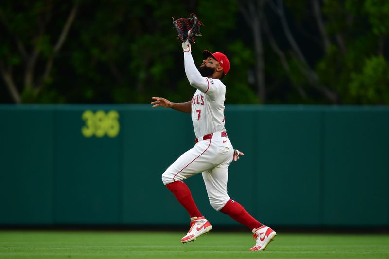 Jun 7, 2024; Anaheim, California, USA; Los Angeles Angels outfielder Jo Adell (7) tracks the fly ball of Houston Astros third base Alex Bregman (2) during the third inning at Angel Stadium. Mandatory Credit: Gary A. Vasquez-USA TODAY Sports