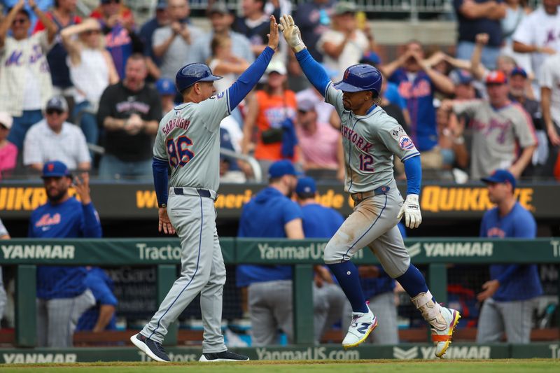 Sep 30, 2024; Atlanta, Georgia, USA; New York Mets shortstop Francisco Lindor (12) celebrates after a home run with third base coach Mike Sarbaugh (86) against the Atlanta Braves in the ninth inning at Truist Park. Mandatory Credit: Brett Davis-Imagn Images