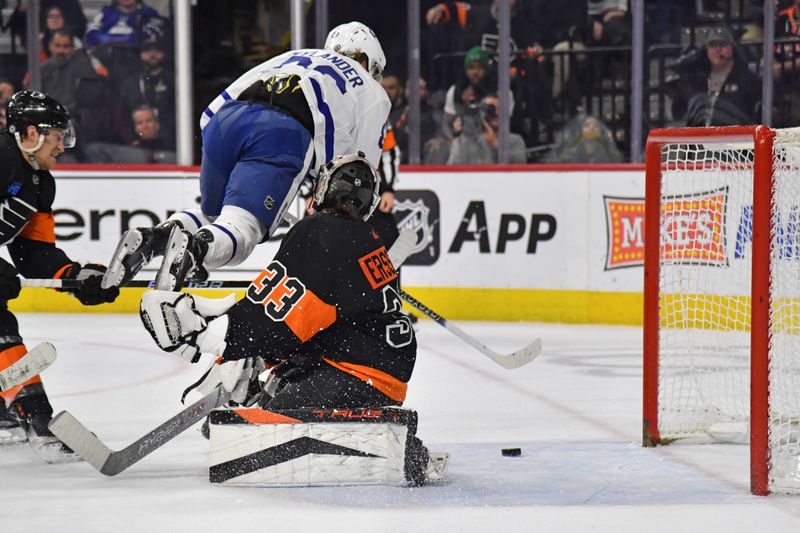 Mar 19, 2024; Philadelphia, Pennsylvania, USA; Toronto Maple Leafs right wing William Nylander (88) soars over Philadelphia Flyers goaltender Samuel Ersson (33) during the second period at Wells Fargo Center. Mandatory Credit: Eric Hartline-USA TODAY Sports