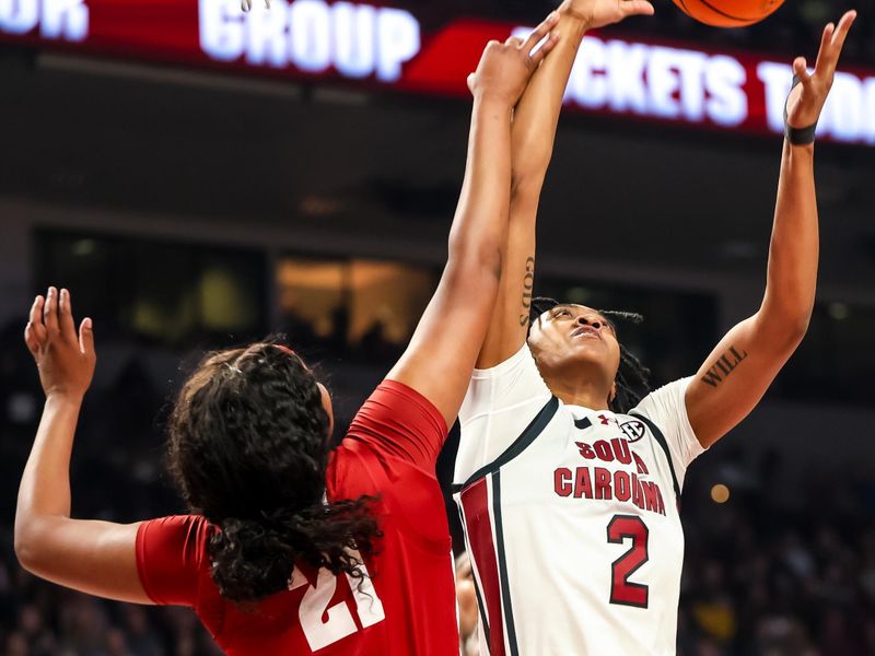 Feb 22, 2024; Columbia, South Carolina, USA; South Carolina Gamecocks forward Ashlyn Watkins (2) grabs a rebound over Alabama Crimson Tide forward Essence Cody (21) in the first half at Colonial Life Arena. Mandatory Credit: Jeff Blake-USA TODAY Sports