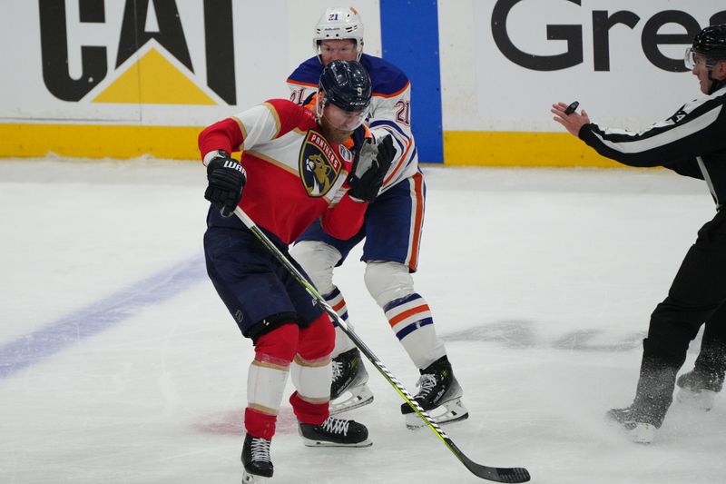 Jun 9, 2025; Sunrise, Florida, USA; Edmonton Oilers center Trent Frederic (21) fights Florida Panthers forward Sam Bennett (9) during the third period in game three of the 2025 Stanley Cup Final at Amerant Bank Arena. Mandatory Credit: Jim Rassol-Imagn Images