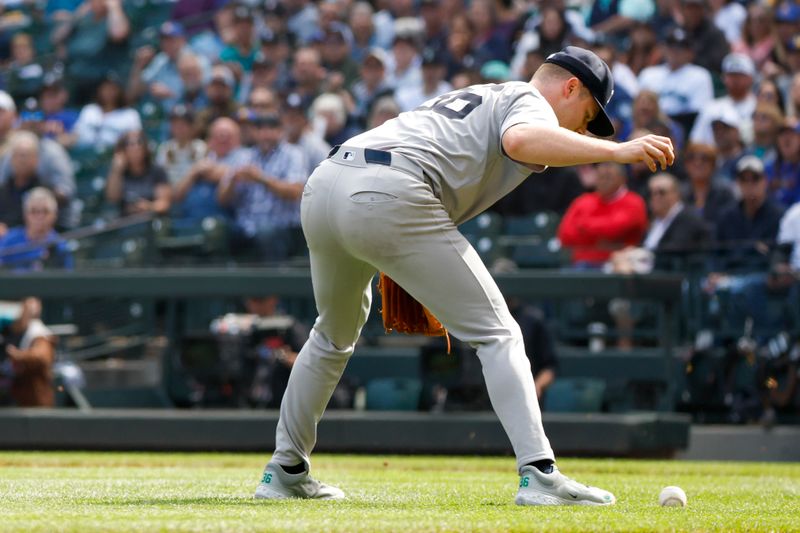 Sep 19, 2024; Seattle, Washington, USA; New York Yankees starting pitcher Clarke Schmidt (36) fields a bunt single by Seattle Mariners right fielder Luke Raley (20, background) during the first inning at T-Mobile Park. Mandatory Credit: Joe Nicholson-Imagn Images
