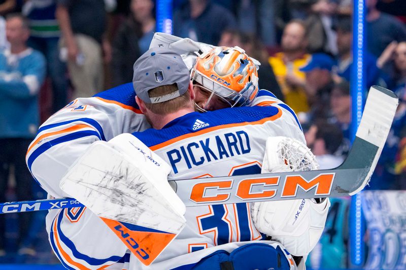 May 20, 2024; Vancouver, British Columbia, CAN; Edmonton Oilers goalie Calvin Pickard (30) and goalie Stuart Skinner (74) celebrate their victory over the Vancouver Canucks in game seven of the second round of the 2024 Stanley Cup Playoffs at Rogers Arena. Mandatory Credit: Bob Frid-USA TODAY Sports