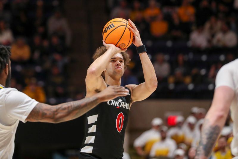 Jan 31, 2024; Morgantown, West Virginia, USA; Cincinnati Bearcats guard Dan Skillings Jr. (0) shoots a three pointer during the first half against the West Virginia Mountaineers at WVU Coliseum. Mandatory Credit: Ben Queen-USA TODAY Sports